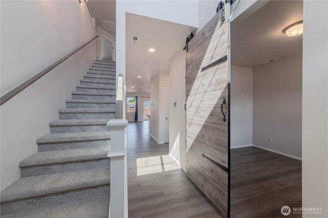 514 Wellington Pl, Sedro Woolley, WA 98284 - stairway featuring a barn door, wood finished floors, and recessed lighting