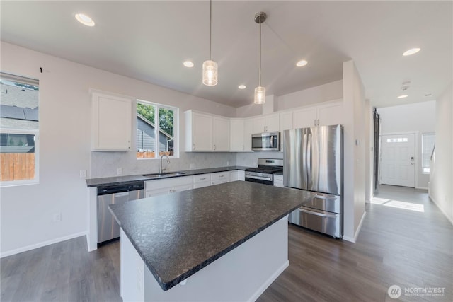 514 Wellington Pl, Sedro Woolley, WA 98284 - kitchen featuring stainless steel appliances, dark countertops, dark wood finished floors, white cabinetry, and recessed lighting