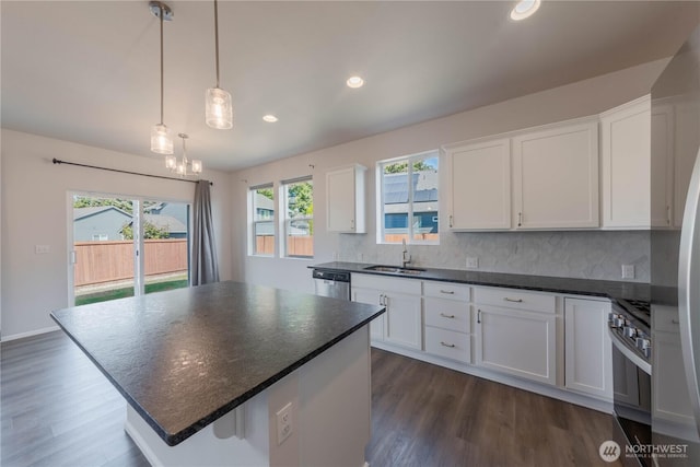 514 Wellington Pl, Sedro Woolley, WA 98284 - kitchen featuring range, dark countertops, decorative backsplash, white cabinets, and recessed lighting