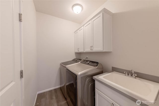 514 Wellington Pl, Sedro Woolley, WA 98284 - laundry room featuring washing machine and clothes dryer, cabinet space, and wood finished floors
