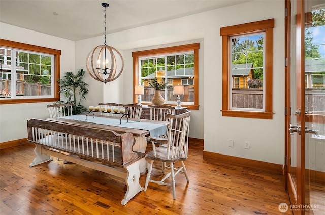 10904 W Lake Joy Dr NE, Carnation, WA 98014 - dining area with a chandelier, wood finished floors, and plenty of natural light