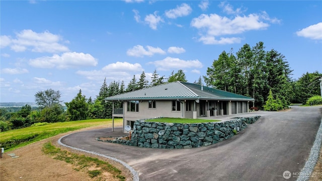1409 Marietta Ave, Bellingham, WA 98226 - view of front of house with a metal roof, asphalt driveway, and a standing seam roof