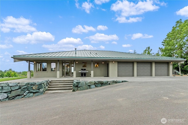 1409 Marietta Ave, Bellingham, WA 98226 - view of front of house with a standing seam roof, a metal roof, a porch, and stucco siding