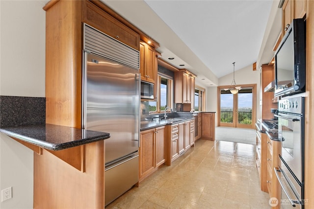 1409 Marietta Ave, Bellingham, WA 98226 - kitchen featuring built in appliances, lofted ceiling, backsplash, a peninsula, and brown cabinets
