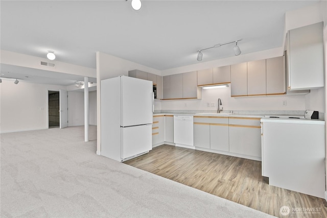 1409 Marietta Ave, Bellingham, WA 98226 - kitchen featuring white appliances, light countertops, track lighting, open floor plan, and washer / dryer