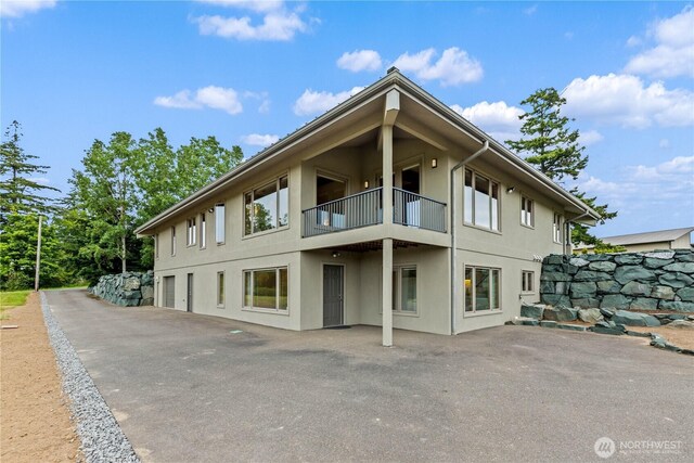 1409 Marietta Ave, Bellingham, WA 98226 - back of property with a balcony, stucco siding, and a patio area