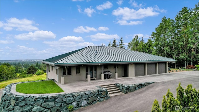 1409 Marietta Ave, Bellingham, WA 98226 - rear view of property with a standing seam roof, a metal roof, a yard, a patio area, and an attached garage