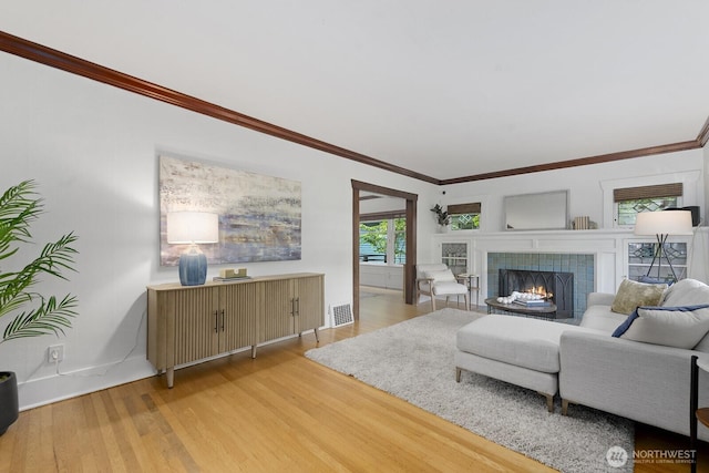 4628 Sunnyside Ave N, Seattle, WA 98103 - living room with light wood finished floors, a fireplace, and crown molding