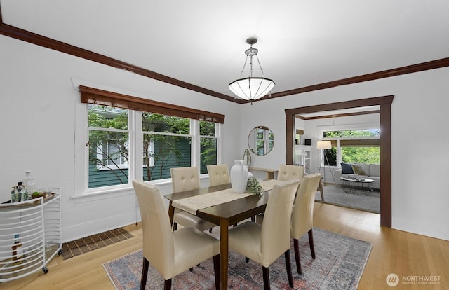 4628 Sunnyside Ave N, Seattle, WA 98103 - dining room with light wood-style floors and ornamental molding