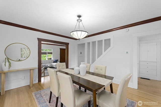 4628 Sunnyside Ave N, Seattle, WA 98103 - dining area featuring stairway, crown molding, and light wood-type flooring