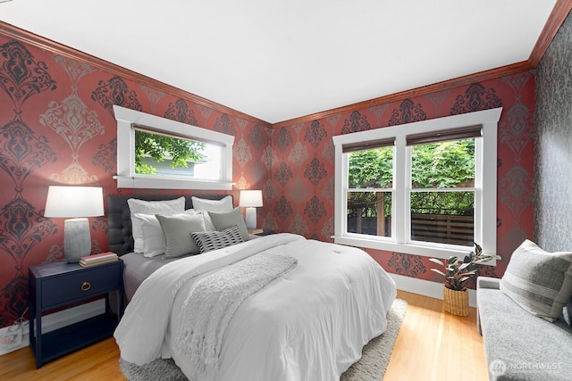4628 Sunnyside Ave N, Seattle, WA 98103 - bedroom featuring wallpapered walls, multiple windows, light wood-style flooring, and ornamental molding
