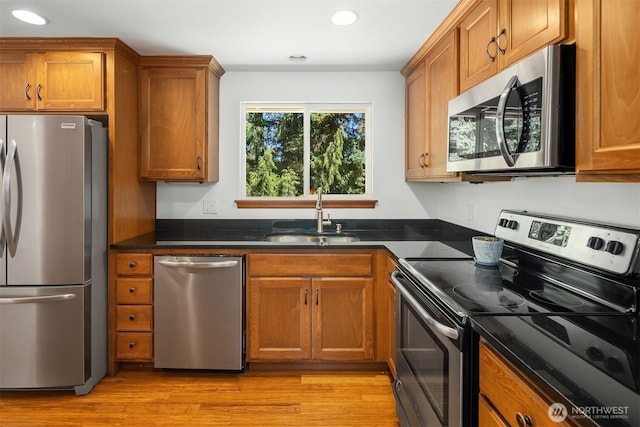 21310 SE 412th Pl, Enumclaw, WA 98022 - kitchen featuring appliances with stainless steel finishes, brown cabinetry, recessed lighting, and light wood-style flooring