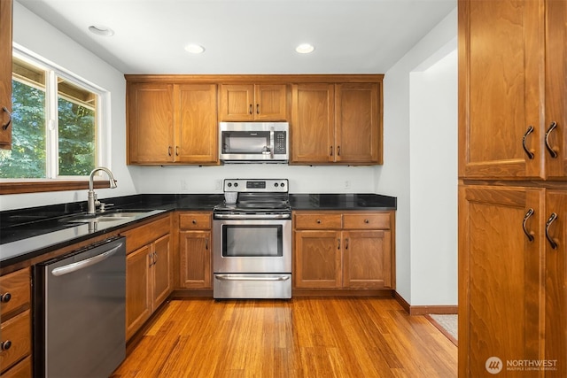 21310 SE 412th Pl, Enumclaw, WA 98022 - kitchen featuring stainless steel appliances, brown cabinetry, dark countertops, and recessed lighting
