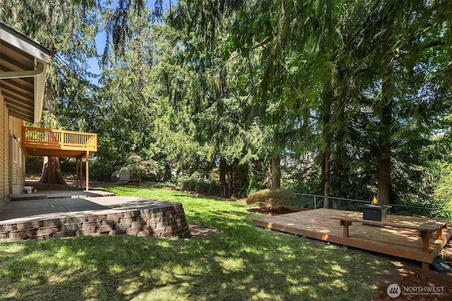21310 SE 412th Pl, Enumclaw, WA 98022 - fenced backyard with a deck, a patio area, and view of wooded area