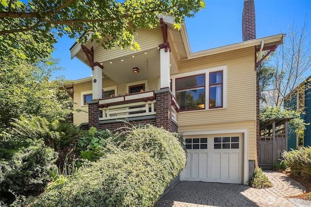 103 NW 62nd St, Seattle, WA 98107 - view of front of property featuring an attached garage, a chimney, driveway, and brick siding