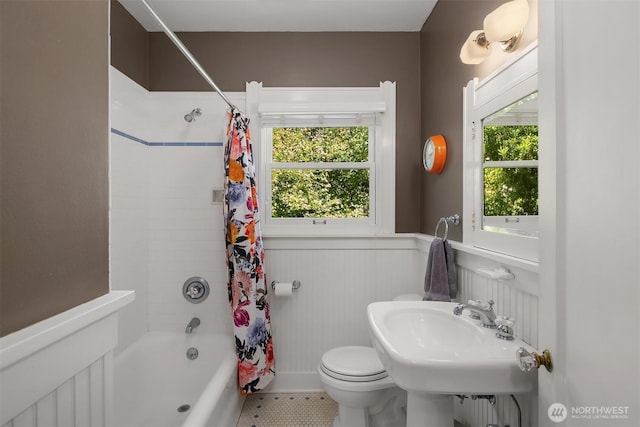 103 NW 62nd St, Seattle, WA 98107 - bathroom featuring healthy amount of natural light, shower / bath combo with shower curtain, a wainscoted wall, and tile patterned floors