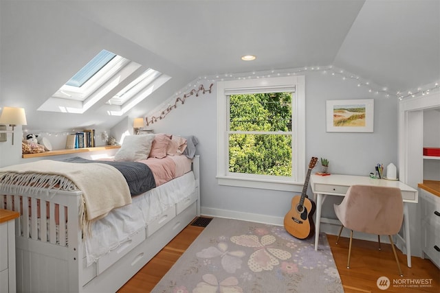 103 NW 62nd St, Seattle, WA 98107 - bedroom with lofted ceiling, a skylight, wood finished floors, and an office area