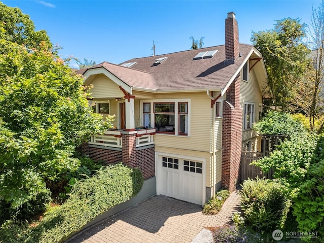 103 NW 62nd St, Seattle, WA 98107 - view of front of house with a chimney, an attached garage, decorative driveway, roof with shingles, and brick siding