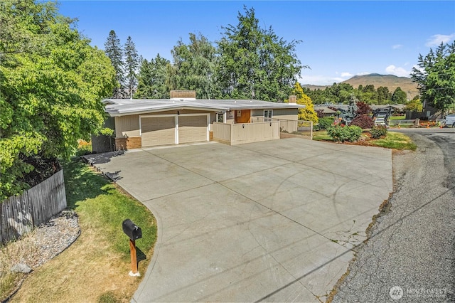 1840 Country Club Dr, East Wenatchee, WA 98802 - mid-century inspired home featuring a chimney, a garage, concrete driveway, and a mountain view