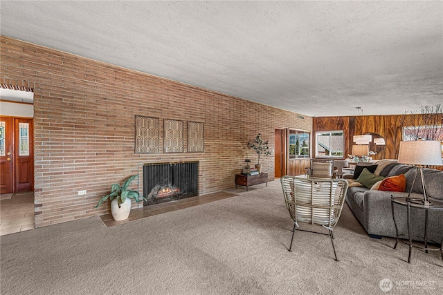 1840 Country Club Dr, East Wenatchee, WA 98802 - living room featuring healthy amount of natural light, a textured ceiling, a brick fireplace, carpet flooring, and wood walls