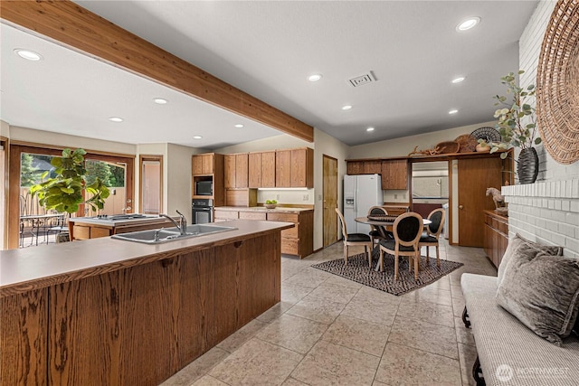 1840 Country Club Dr, East Wenatchee, WA 98802 - kitchen featuring white fridge with ice dispenser, recessed lighting, brown cabinetry, black microwave, and light countertops