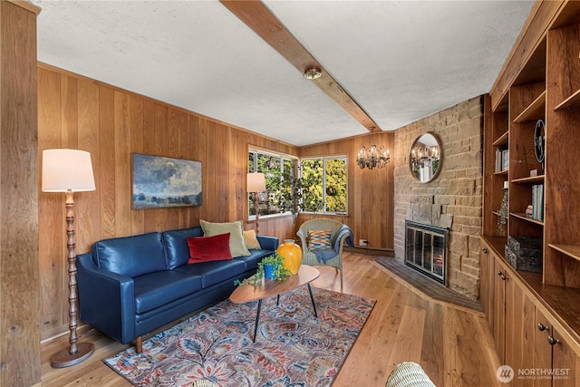 1840 Country Club Dr, East Wenatchee, WA 98802 - living area with wood walls, beam ceiling, light wood-style flooring, a fireplace, and a textured ceiling