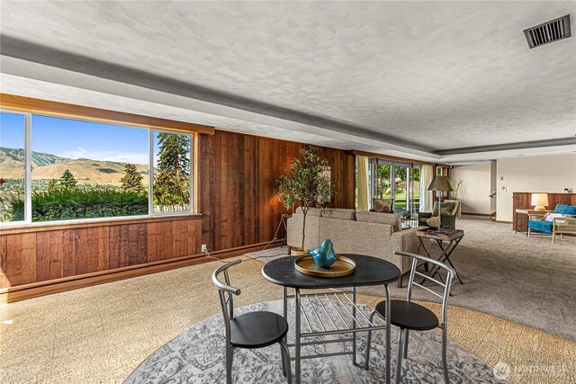 1840 Country Club Dr, East Wenatchee, WA 98802 - living area with carpet, a mountain view, wooden walls, and a textured ceiling