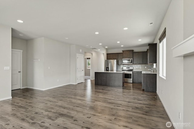 6729 283rd Pl NW, Stanwood, WA 98292 - kitchen featuring stainless steel appliances, a kitchen island, open floor plan, light countertops, and dark wood-type flooring
