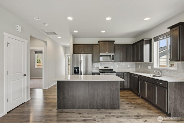 6729 283rd Pl NW, Stanwood, WA 98292 - kitchen featuring stainless steel appliances, dark brown cabinets, decorative backsplash, a kitchen island, and recessed lighting
