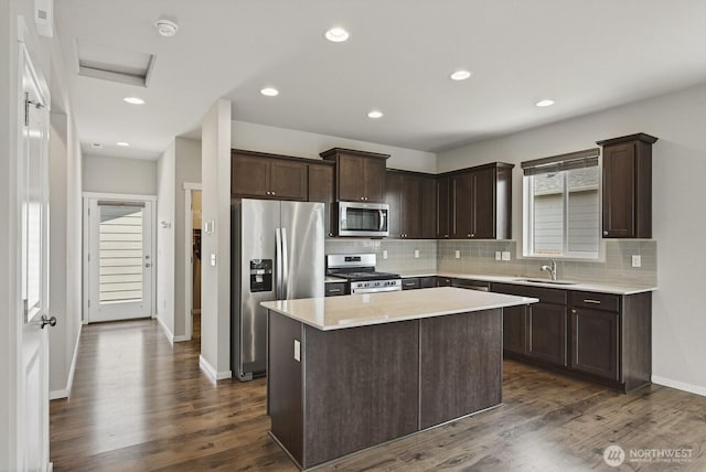 6729 283rd Pl NW, Stanwood, WA 98292 - kitchen featuring stainless steel appliances, dark brown cabinets, decorative backsplash, light countertops, and recessed lighting