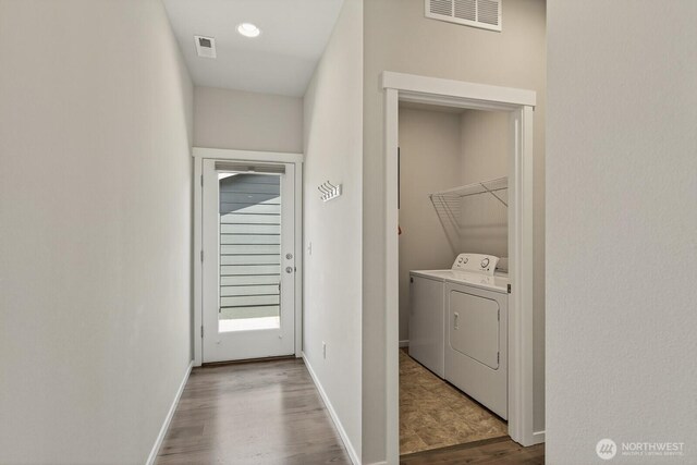 6729 283rd Pl NW, Stanwood, WA 98292 - laundry room featuring washer and dryer and wood finished floors