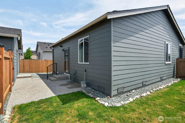 6729 283rd Pl NW, Stanwood, WA 98292 - back of house with crawl space, a fenced backyard, and a patio