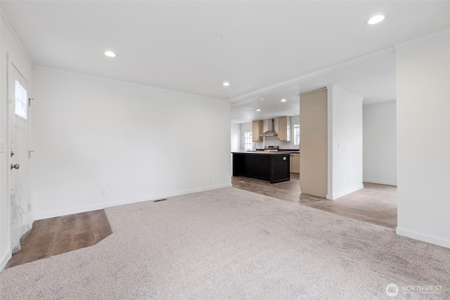 1264 Russell Dr, Coupeville, WA 98239 - unfurnished living room with light carpet, recessed lighting, healthy amount of natural light, crown molding, and light wood-style flooring
