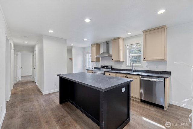 1264 Russell Dr, Coupeville, WA 98239 - kitchen with wall chimney exhaust hood, appliances with stainless steel finishes, dark countertops, cream cabinets, and a kitchen island
