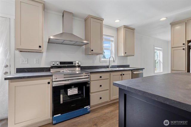 1264 Russell Dr, Coupeville, WA 98239 - kitchen featuring wall chimney exhaust hood, stainless steel appliances, dark countertops, cream cabinets, and recessed lighting