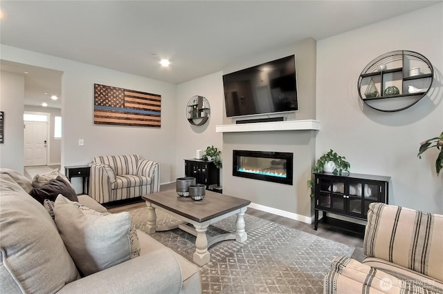 7804 208th Ave E, Bonney Lake, WA 98391 - living area with wood finished floors, recessed lighting, and a glass covered fireplace