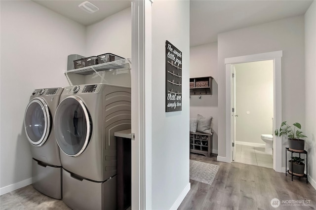 7804 208th Ave E, Bonney Lake, WA 98391 - washroom with washing machine and clothes dryer and wood finished floors