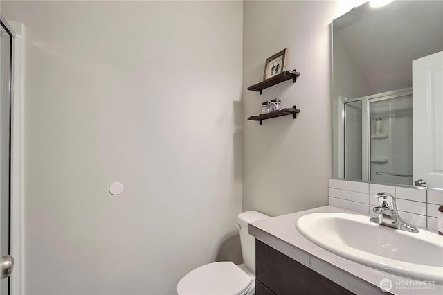 7804 208th Ave E, Bonney Lake, WA 98391 - bathroom featuring vanity, an enclosed shower, and decorative backsplash