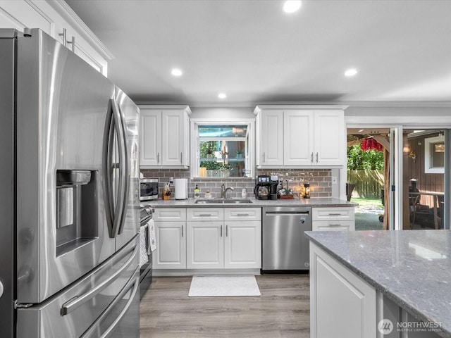 25107 Old Owen Rd, Monroe, WA 98272 - kitchen featuring appliances with stainless steel finishes, decorative backsplash, white cabinetry, light stone countertops, and recessed lighting