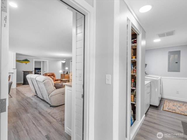 25107 Old Owen Rd, Monroe, WA 98272 - hallway with electric panel, independent washer and dryer, light wood-style flooring, and a wainscoted wall