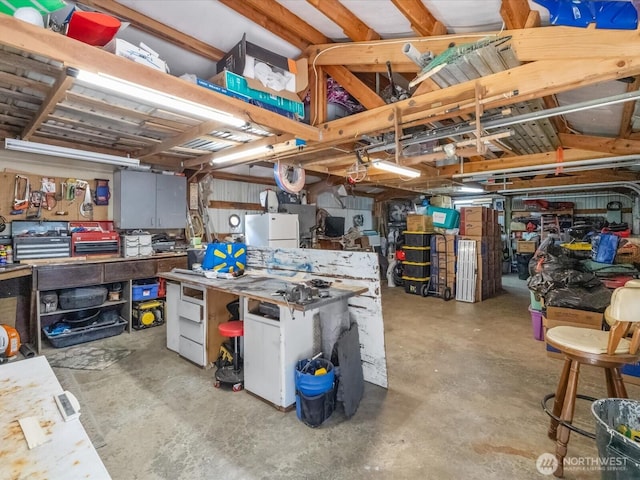25107 Old Owen Rd, Monroe, WA 98272 - garage featuring a workshop area and freestanding refrigerator
