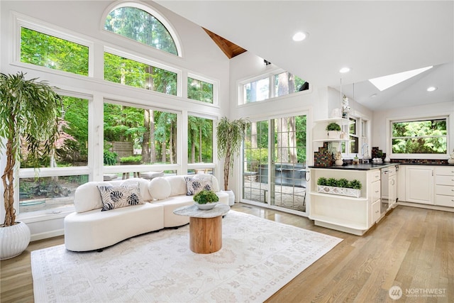 5265 140th Ave NE, Bellevue, WA 98005 - living room with a skylight, high vaulted ceiling, light wood-style flooring, and recessed lighting