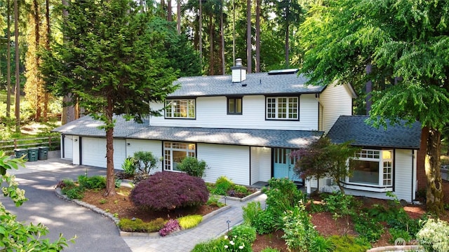 5265 140th Ave NE, Bellevue, WA 98005 - view of front of property featuring asphalt driveway, a chimney, a garage, and roof with shingles