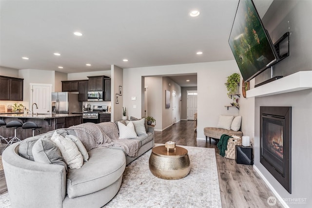 2726 Kacie Ct NE, Lacey, WA 98516 - living room featuring light wood-style flooring, recessed lighting, and a glass covered fireplace