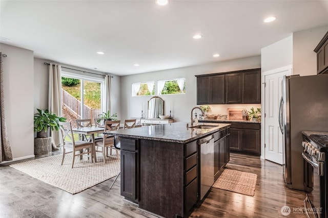 2726 Kacie Ct NE, Lacey, WA 98516 - kitchen featuring stainless steel appliances, dark wood-style flooring, dark brown cabinetry, dark stone counters, and recessed lighting