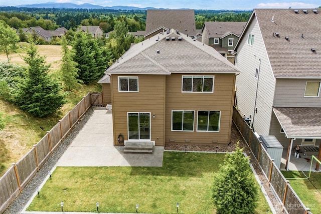 2726 Kacie Ct NE, Lacey, WA 98516 - rear view of house featuring a patio, a fenced backyard, a mountain view, and a shingled roof