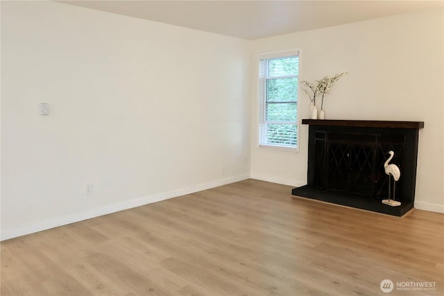 147 S 329th Pl Unit A, Federal Way, WA 98003 - unfurnished living room featuring wood finished floors and a fireplace with raised hearth
