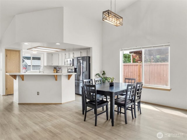 5415 Komachin Loop SE, Lacey, WA 98513 - dining area featuring high vaulted ceiling and light wood-style flooring