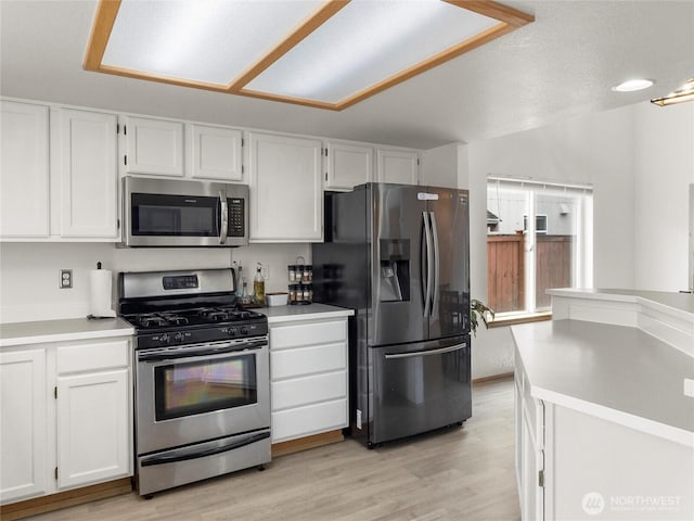 5415 Komachin Loop SE, Lacey, WA 98513 - kitchen featuring stainless steel appliances, white cabinetry, light countertops, and light wood-type flooring