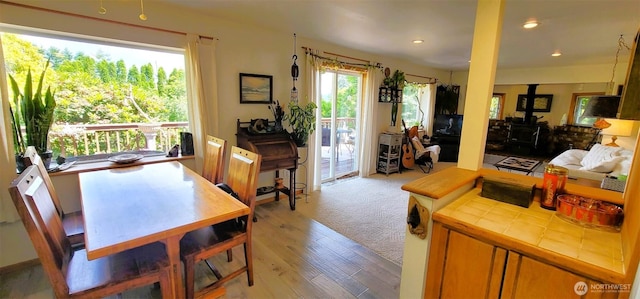 2904 271st St, Ocean Park, WA 98640 - dining area featuring a wood stove, light wood-type flooring, and recessed lighting